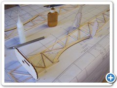 Joining the fuselage sides begins with gluing the mid section formers in place. Drafting triangles are used to insure the formers are aligned properly.