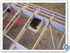 I secured the Dymond D-47 servos for the ailerons into their mount boxes with silicone caulk.