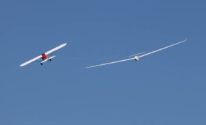 Bill Staley’s Ventus taking a turn behind Peter George’s Aeroworks Carbon Cub